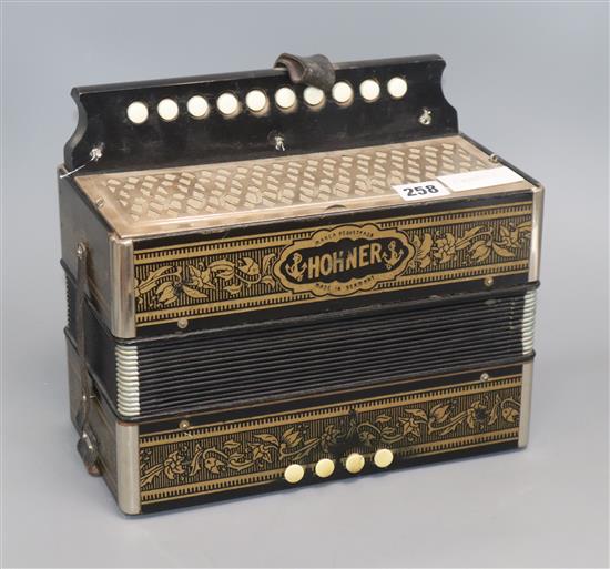 A Hohner Melodian Accordian and booklet